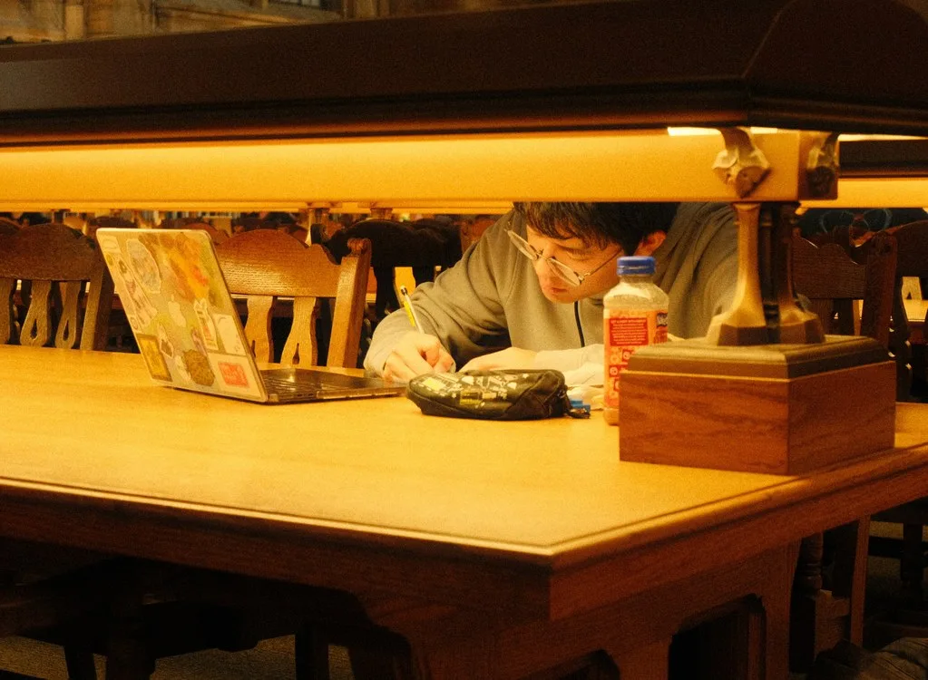 Graduate student conducting research in a library